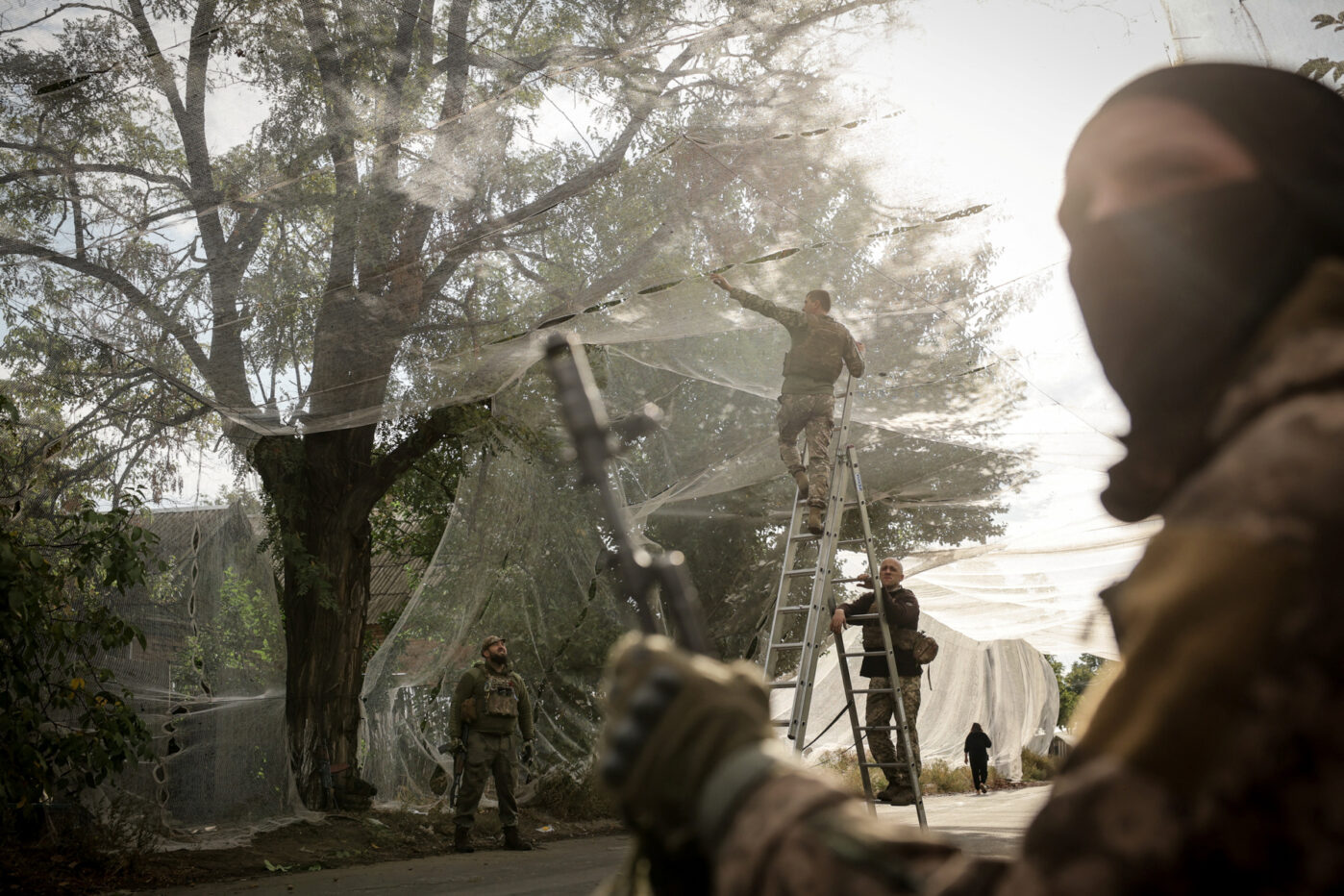 Ukrainian military personnel install anti-drone nets over a&nbsp;road in&nbsp;the frontline town of&nbsp;Konstantinovka, Donetsk region, Ukraine